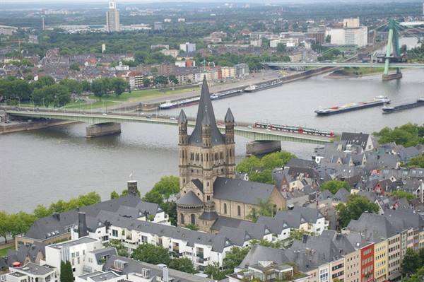 Great St. Martin Church in Cologne overlooks the Rhine with bridges and barges