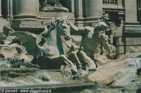 Trevi Fountain, marble statues of triton and horse in sunlight