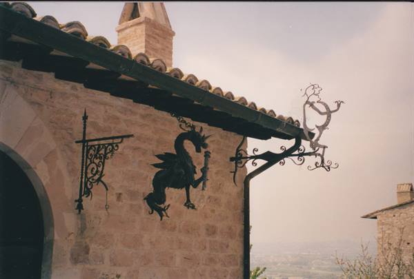 Wrought-iron dragon mounted on stone wall in San Marino