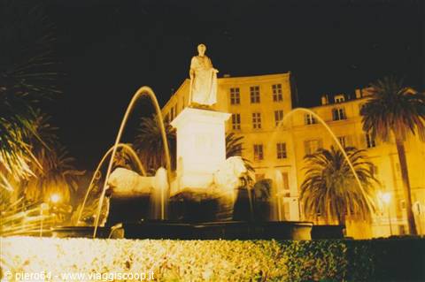 Napoleon statue on Foch square fountain in Ajaccio, glowing at night