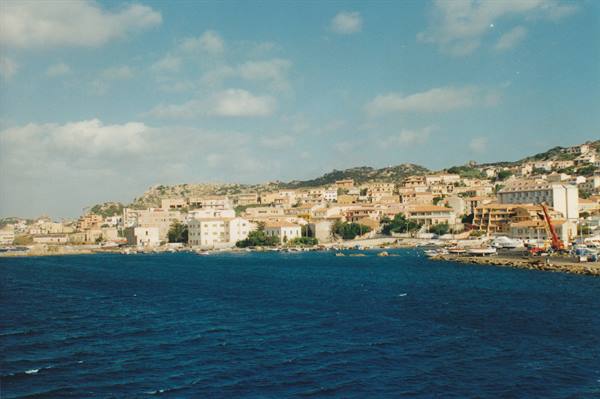 Colorful houses on rocky coast overlooking the blue sea