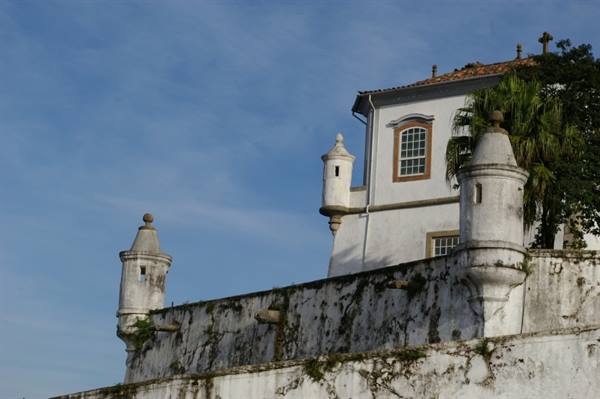 White watchtowers on colonial walls under a blue sky