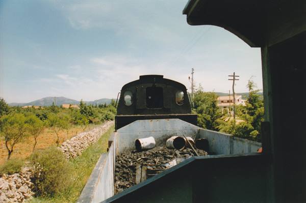 From the wagon, steam locomotive with coal, tracks between dry stone walls and Mediterranean scrub