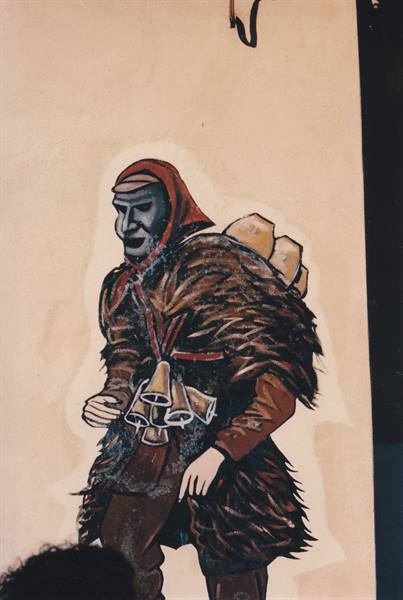 Mural of a mamuthone wearing black mask, fur cloak and cowbells