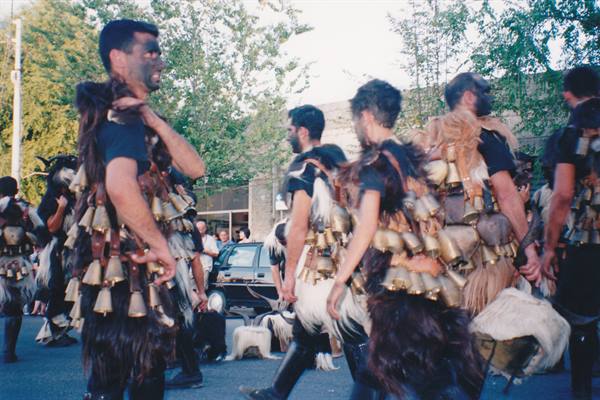 Mamuthones masks in goat skins and bronze bells parade through the street