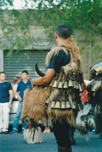 Man in Mamuthones costume with bronze bells and fur in Mamoiada