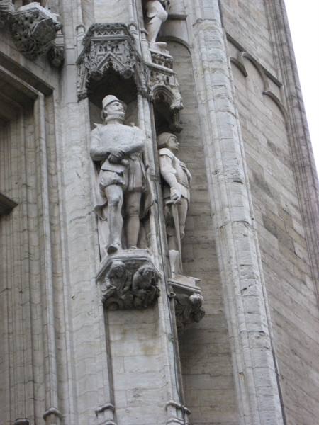 Stone statues of knights in Gothic niches on Brussels town hall