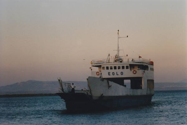 Ferry EOLO at sea, white hull with open bow, pink twilight sky