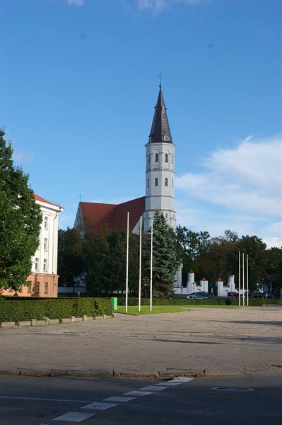 Šiauliai Cathedral, white tower and red roof under blue sky