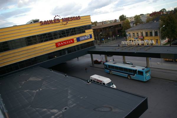 Blue bus and van at the terminal beside Saules Miestas shopping center