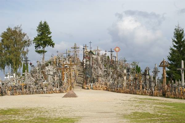 Hill of Crosses: thousands of wooden and metal crosses under a cloudy sky