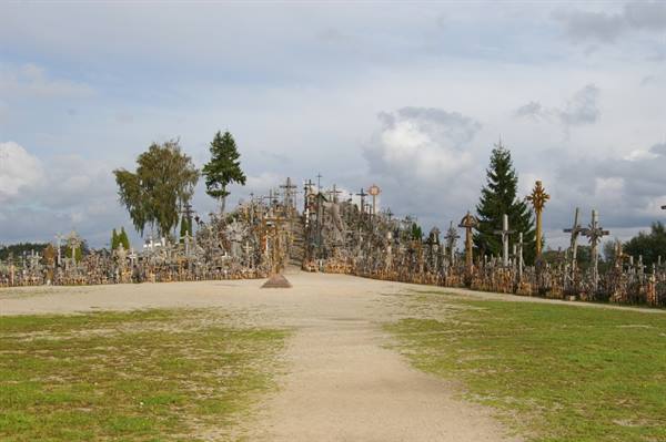 Sandy path among thousands of wooden and metal crosses at the Hill of Crosses