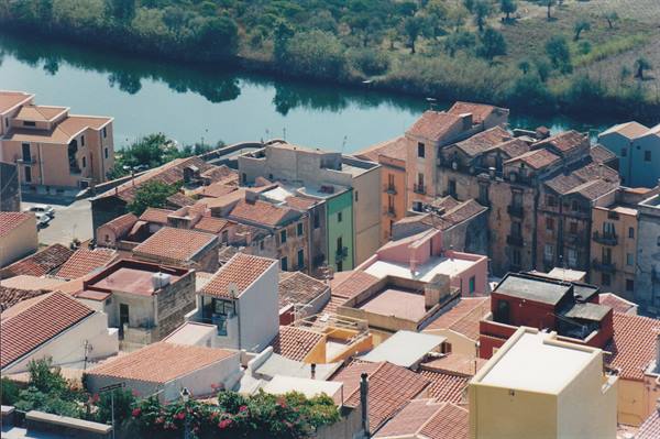 Colorful rooftops of Bosa overlooking the Temo river, midday light