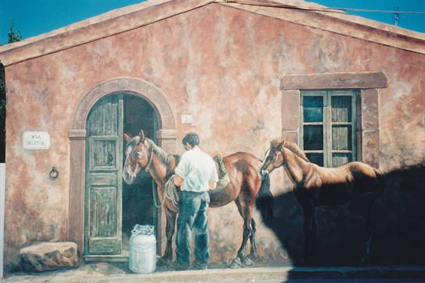 Painted mural: farmer saddles two horses by a pink house