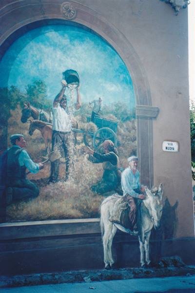 Mural painted on wall in Via Nuova, farmers at work, man on donkey
