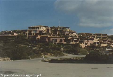 Tourist village with ochre houses built in terraces on the green hillside