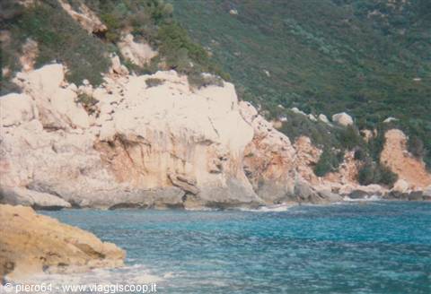 White granite cliffs and Mediterranean scrub over turquoise sea, Sardinia