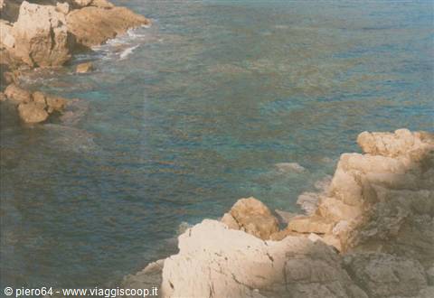 White limestone rocks frame turquoise sea, Otranto