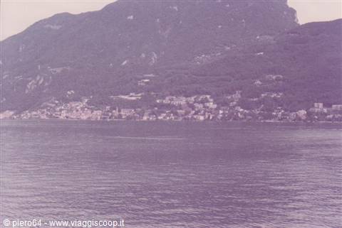 Lakeside town at the foot of a wooded mountain