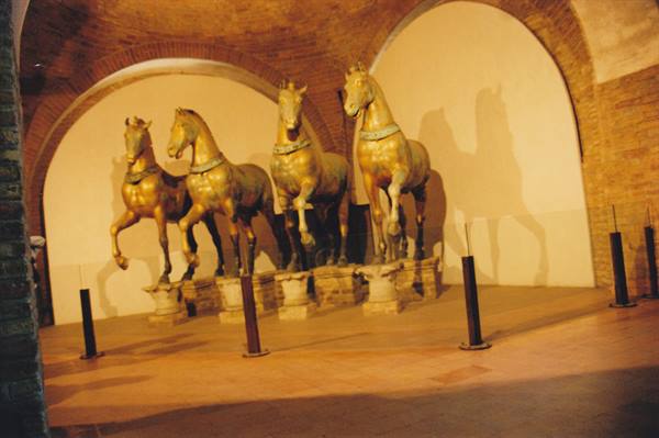 The four bronze horses of St Mark's displayed under brick vaults in Venice