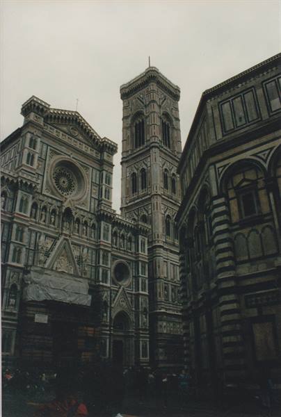 Florence Cathedral and Giotto's bell tower, white and green marble under a grey sky