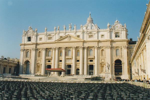 St. Peter's Basilica facade, empty chairs in the sunny square