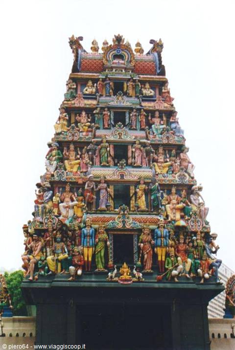 Gopuram of Sri Mariamman Temple in Singapore, colorful statues under white sky
