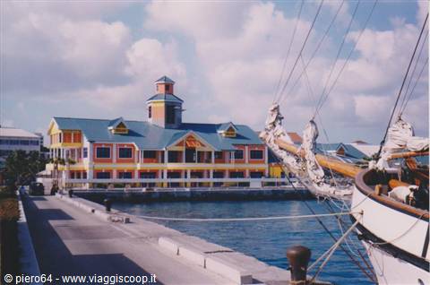 Nassau waterfront with colorful building, blue roof and ship rigging