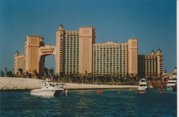 Yacht on the water in front of the pink Atlantis Paradise Island hotel