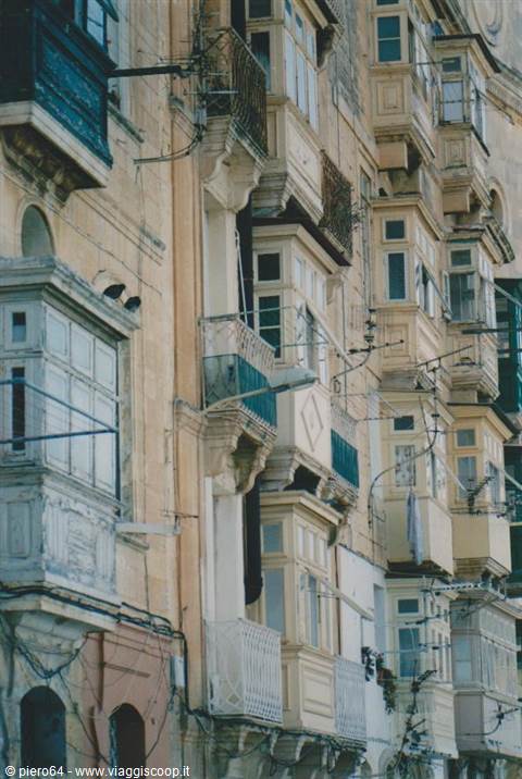 Limestone facade with traditional enclosed wooden balconies, Valletta