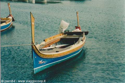 Traditional wooden boat painted blue and yellow moored in the harbor