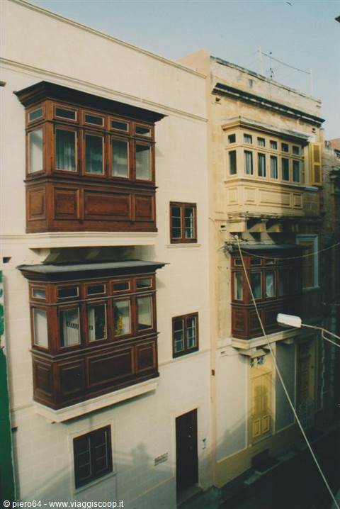 Traditional Maltese wooden closed balconies on cream facades, Valletta morning light