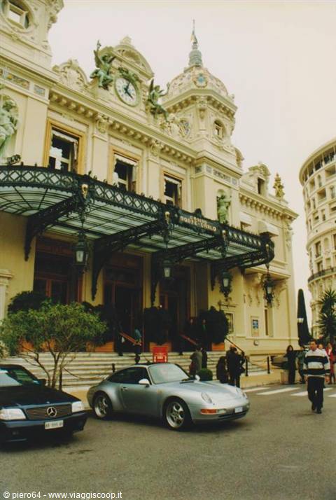 Porsche parked outside the Monte Carlo Casino entrance among pedestrians