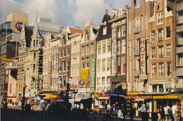 Amsterdam facades on Damrak with hotel signs
