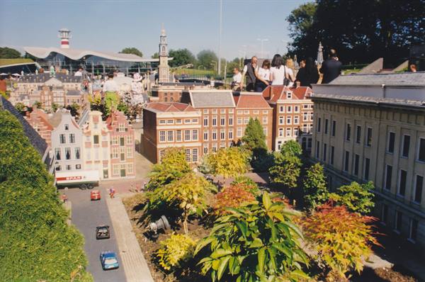 Visitors among the miniature buildings at Madurodam in the sun