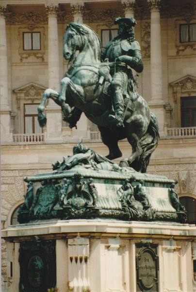 Green bronze equestrian statue in front of the Hofburg imperial palace