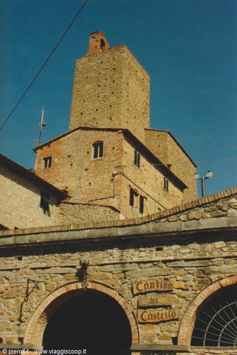 Stone tower above the Cantina del Castello arches, sunny light