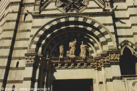 White and green striped marble facade, statues beneath the church archivolt