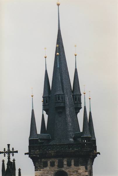 Gothic slate spires with golden pinnacles of Týn Church in Prague