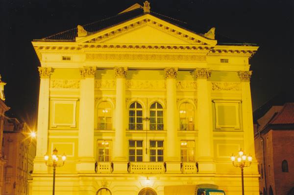 Słowacki Theatre in Kraków glowing yellow at night