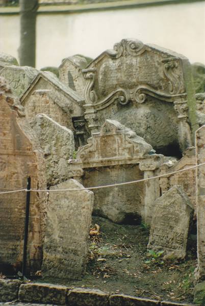 Ancient weathered gravestones crowded together in Prague's Old Jewish Cemetery