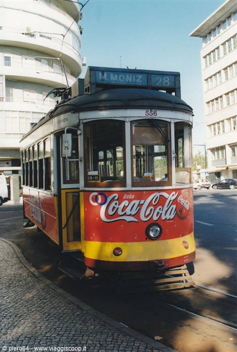 Tram 28 to Martim Moniz with Coca-Cola ads turning in Lisbon