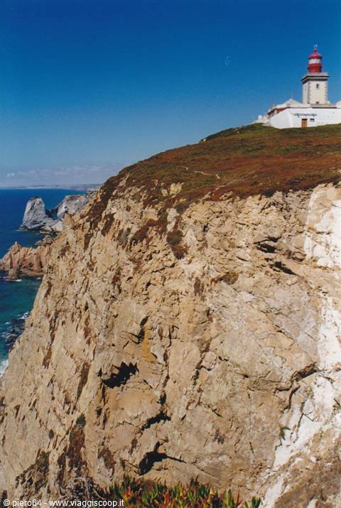 Cabo da Roca lighthouse above rocky cliffs over the Atlantic