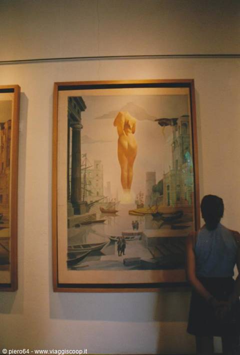Visitor looking at a Dalí painting in the Figueres museum