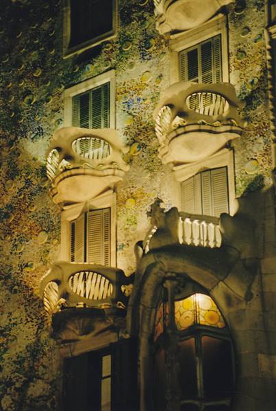 Casa Batlló in Barcelona, sculpted stone balconies illuminated at night