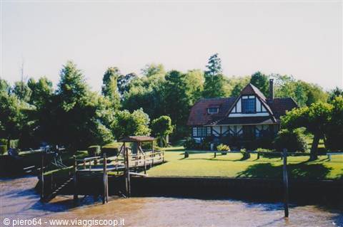 Timber and brick house by the river with wooden pier, Tigre Delta