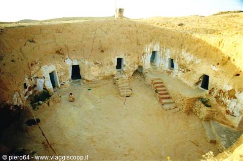 Sunken courtyard carved in sandstone, whitewashed doorways and stairs, Matmata
