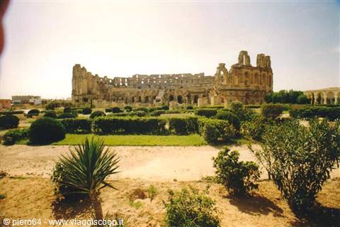 Roman amphitheatre of El Jem, ancient stone walls among gardens and shrubs