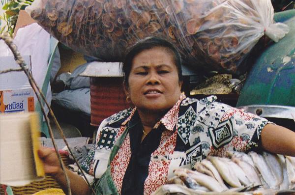 Woman at fish market selling fresh fish