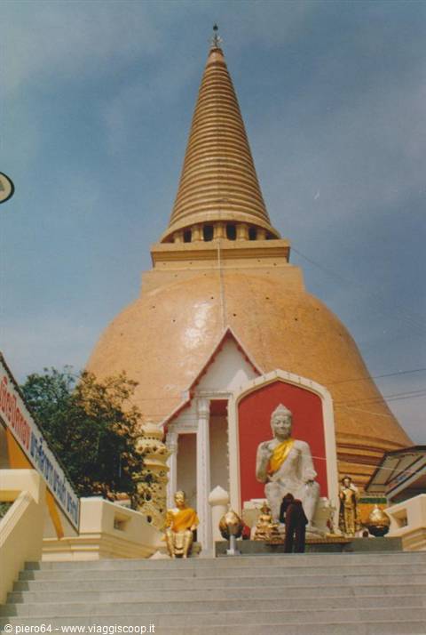 Golden stupa at Nakhon Pathom with seated Buddha in front